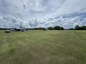 May be an image of golf cart, grass and golf course
