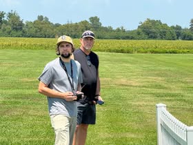 May be an image of golf, golf cart and golf course