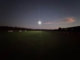 May be an image of eclipse, twilight and grass